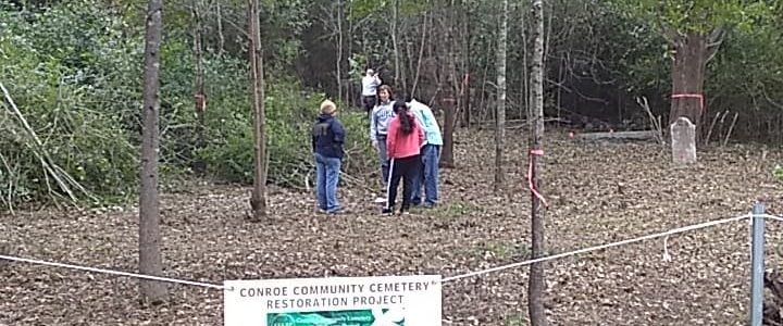 Cemetery cleaing with Conroe Community Cemetery Restoration Project sign
